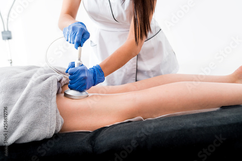 Anti-cellulite treatment at medical spa center, vacuum massage procedure