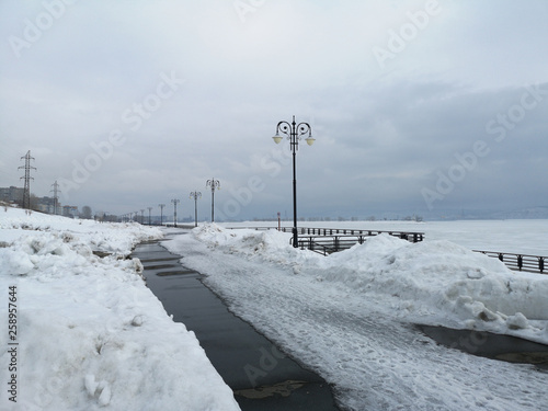 Embankment in the snowy Russian landscape in early spring