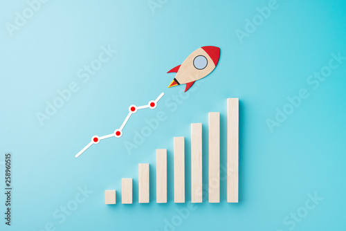 Rocket and chart on blue background business financial start up growth success concept object design