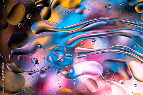 Abstract colorful liquid water splash and bubbles background. Macro photography