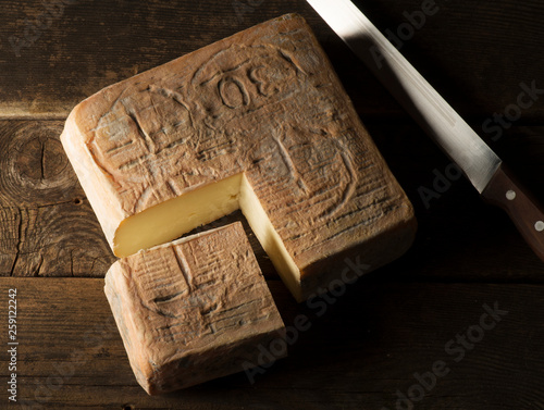 Taleggio cheese on the wooden table