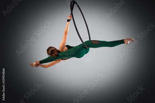 A female gymnast performing exercises on an air ring (hoop)