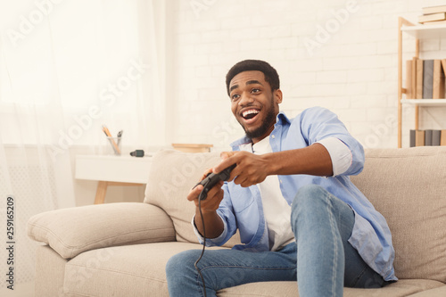 Young man playing video games at home