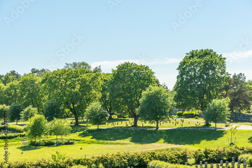 View over lush meadows and one of many cemeteries located at Skogskyrkogården