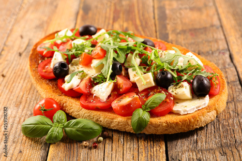 italian bruschetta with tomato, mozzarella, olive and basil