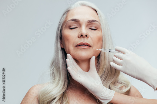 Female getting anti aging shots on her face