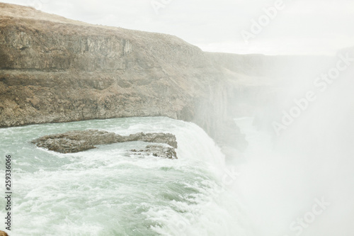  View of a large waterfall in Iceland. June summer day near the raging mountain river and waterfall