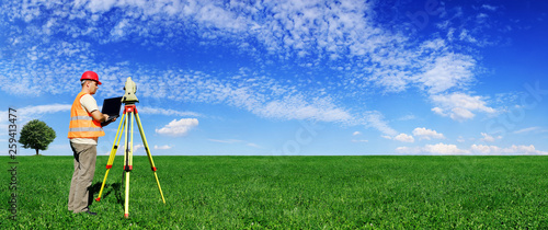 Surveyor on green field