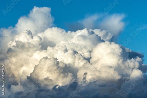 Huge fluffy cumulus cloud has formed in summer. Formation in the sky before the storm.