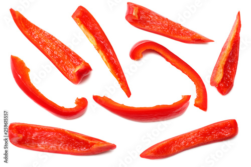 cut slices of red sweet bell pepper isolated on white background top view
