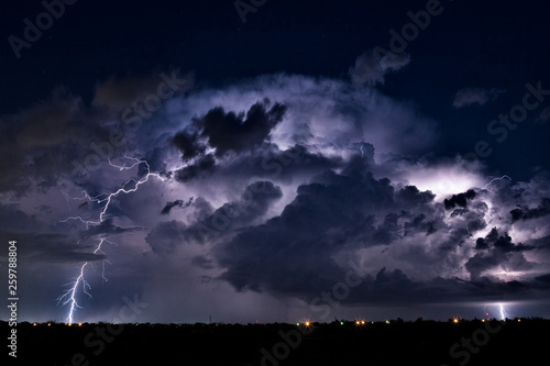 Thunderstorm cloud and lightning strike in the night sky