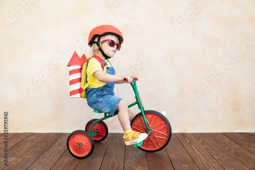 Kid playing with toy rocket at home