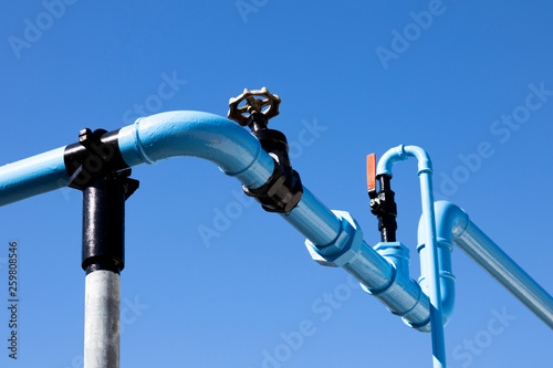 Blue painted pipework supplying compressed air to manufacturing buildings