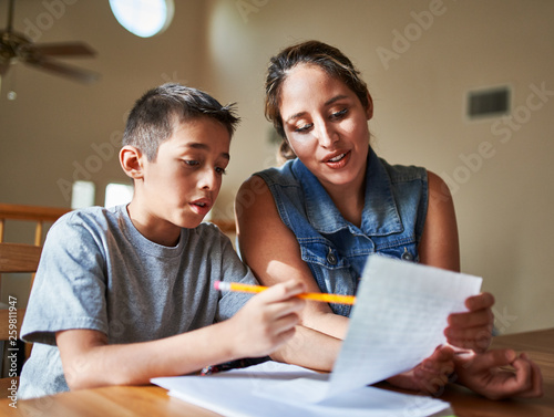 mother helping son with homework