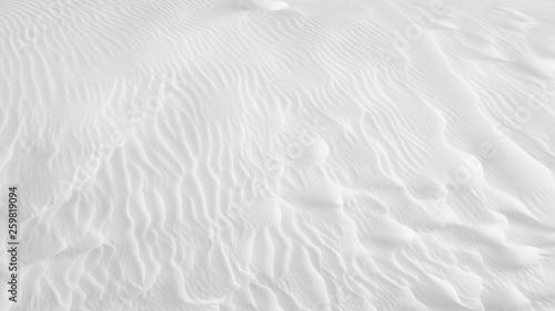 White sand texture background with wave pattern and insect trails 