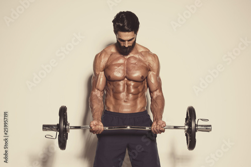 Handsome Muscular Men Exercise With Weights