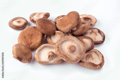 bunch of uncooked shiitake mushrooms isolated on white background