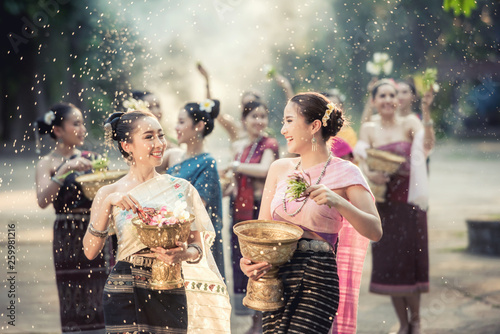 Vientiane Laos APRIL 4 2019 : Young happy beauty Asian woman splashing water during Water Songkran festival ,Thailand Laos traditional.