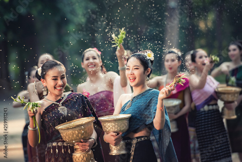 Vientiane Laos APRIL 4 2019 : Young happy beauty Asian woman splashing water during Water Songkran festival ,Thailand Laos traditional.