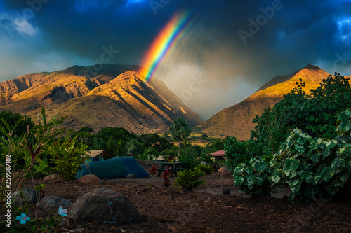 Rainbow over the mountains and tent set in the camping. Maui, Hawaii