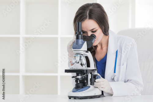 Young scientist with microscope