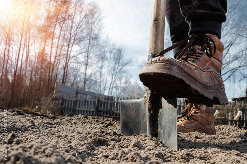 Boots and shovel closeup. The concept of the garden, the beginning of the season, summer cottage.