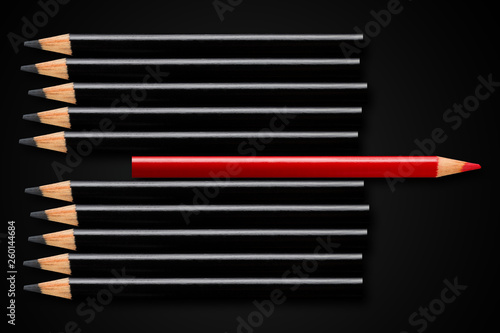 Business concept of disruption, leadership or think different; red pencil in row of black pencils pointing in opposite direction