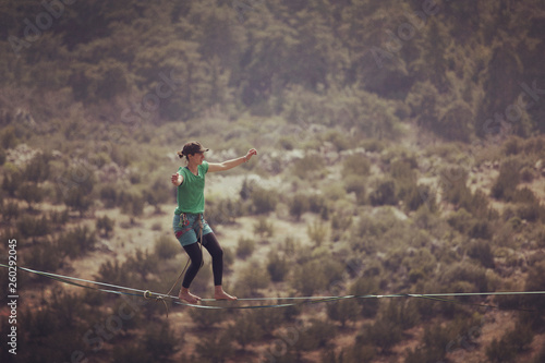 Woman balancing on the rope concept of risk taking and challenge.