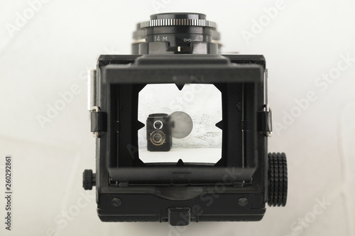 The old medium format film TLR camera, camera for modern lomography on white cement background.