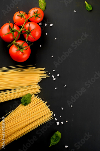 spaghetti paste on dark background with cherry tomatoes