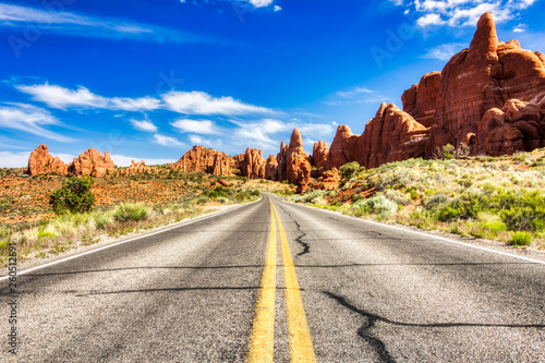 Driving through the-Desert with Monument Rock along the Road During Sunny Day, Arches NP