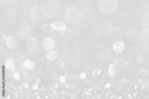 Silver white glittering Christmas lights. Blurred abstract background.