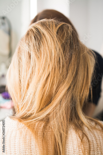 blond woman with long hair in hair studio