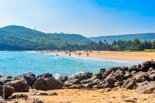 Yarada Beach, Visakhapatnam, India 10 December 2018 - People relaxing and enjoying in Yarada Beach. The Coast area is surrounded by hills and Bay of Bengal with lush green trees and golden soft sands.