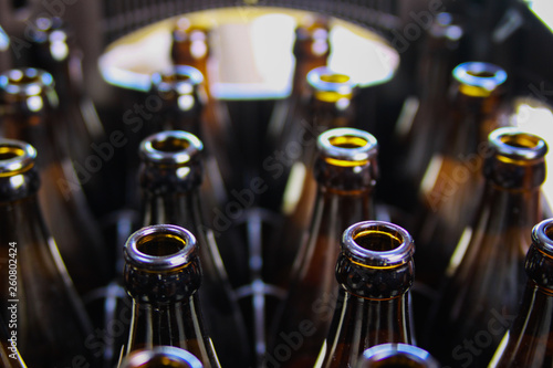 Close up of brown empty beer bottles in a case