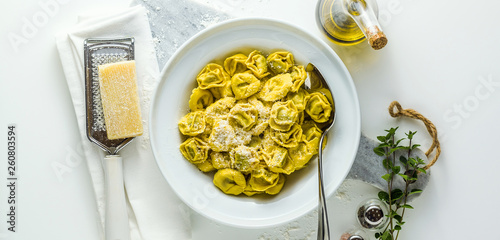 banner of plate of italian cooked ravioli tortellini with parmesan cheese on the table. healthy Mediterranean foodtable. healthy Mediterranean food