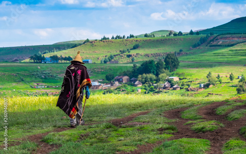 Basotho man with basotho blanket and basotho hat walking in the mountains in Semonkong, Lesotho, Southern Africa