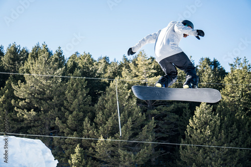 Snowboarder starts jump