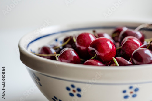 Healthy snack of shiny, red bing cherries in Polish pottery bowl