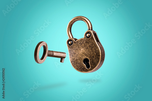 levitating closed bronze lock with key on azure background