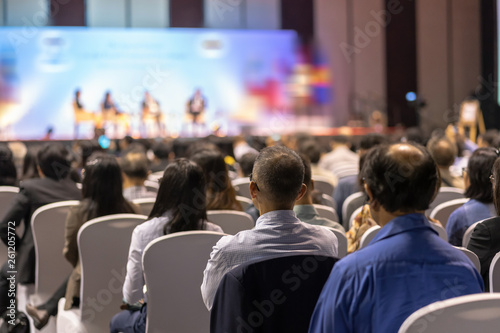 Rear view of Audience listening Speakers on the stage in the conference hall or seminar meeting, business and education about investment concept