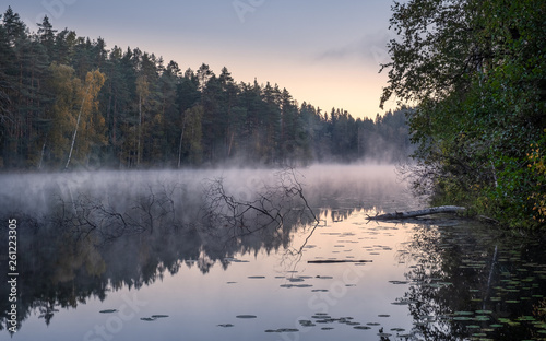 Beautiful landscape with lake fog and sunrise at autumn morning in Finland