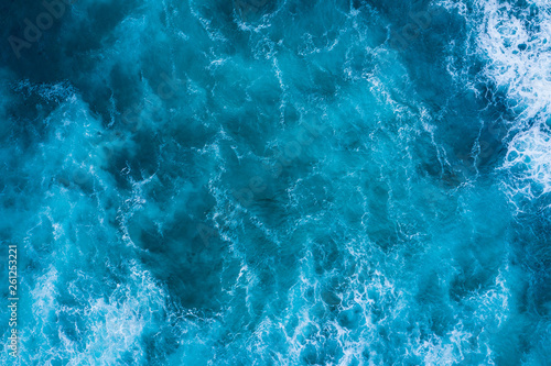 Top view of blue frothy sea surface. Shot in the open sea from above.