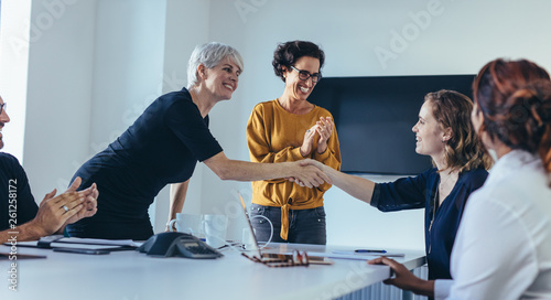 Team congratulating and appreciating a colleague