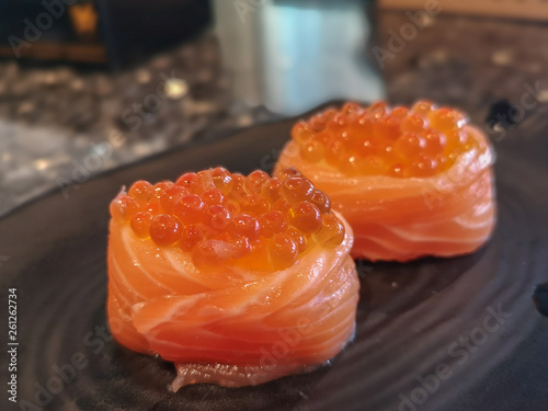 Close up Salmon Ikura Gunkan sushi.A popular Japanese food made of the basic ingredients with rice seaweed accompanied by salmon and fish roe.