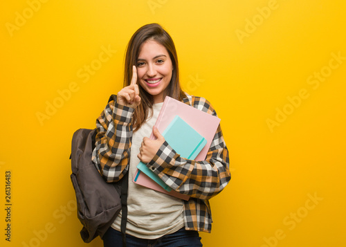 Young student woman showing number one