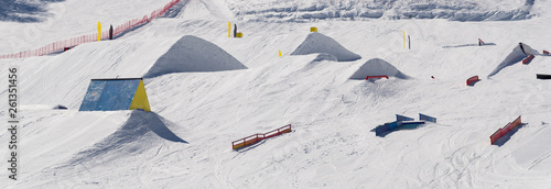 Snowpark with ski ramps, kickers, rails for big air jumping, jibbing, etc. of freestyle snowboarders and skiers