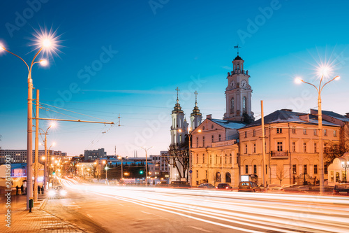 Vitebsk, Belarus. Traffic At Lenina Street, Holy Resurrection Church And City Hall In Evening Or Night Illumination At Winter