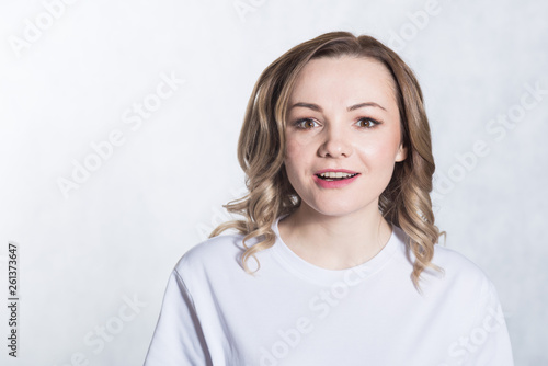 Portrait of a young surprised woman on white background.
