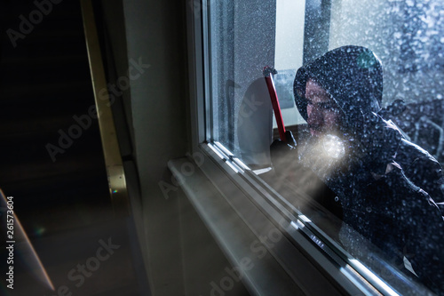 Burglar Looking Into A House Window